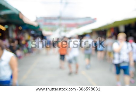 Blurred background : people shopping at market fair in sunny day, blur background with bokeh.