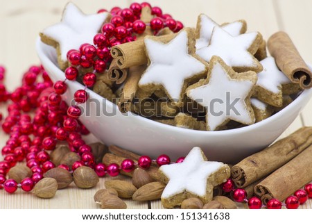 typical christmas cinnamon star cookies, nuts and cinnamon sticks