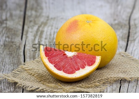 red grapefruit on old wooden background