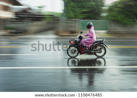 Motorcycle raincoat In the rain,people drive motorbike in rain day,motion blur of rush on running step,blur.
