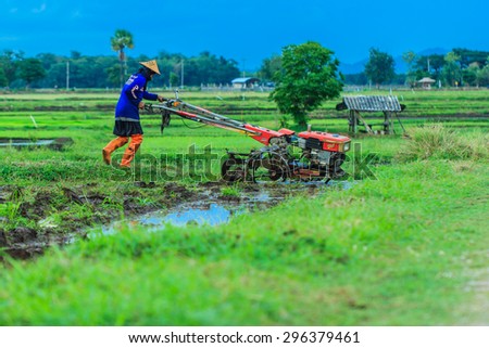 The farmer with a tractor after the rainy season to start walking-but to sow the. Thailand farmers around everywhere are starting to plow their rice-Lampang Thailand