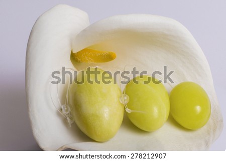 Three jade eggs for the development of intimate muscles lie on a white flower on a white background