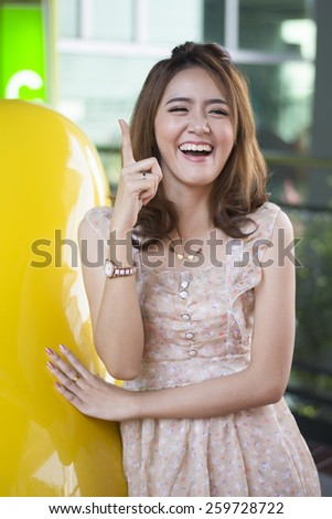Asian woman thinking in looking pensive and happy in casual clothes