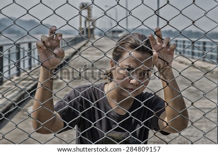 woman hand and steel cage on the evening light, concept of the freedom