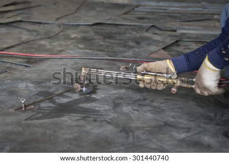 welder is cutting steel plate wirh gas cutting