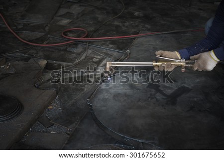 welder is cutting steel plate wirh gas cutting
