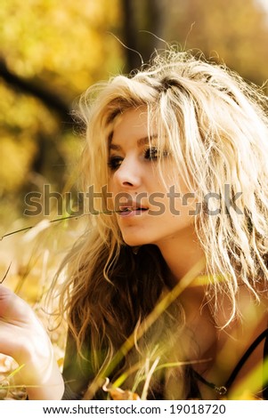 Girl lying in the front with blade of grass