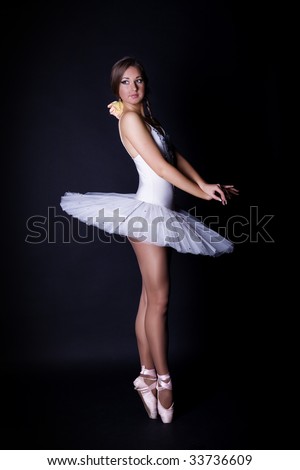 stock photo Ballerina in white tutu on black background