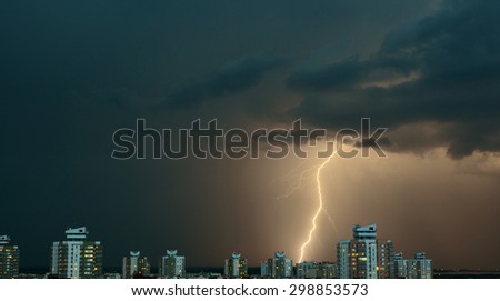 The most real summer thunderstorm, bright lightning among dark clouds over the city.