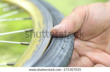 Repairing a flat tire of an bicycle tire. Patched up inner tube of an bicycle tire