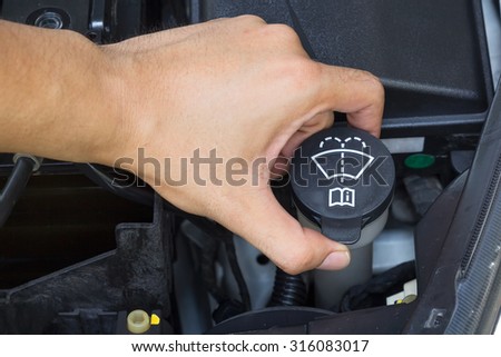 Car repair service, Auto mechanic checking water level in a engine