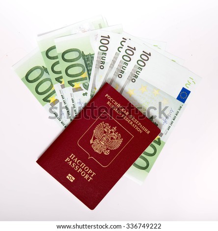 The Russian passport in a red cover lies on a pile of notes (euro)
