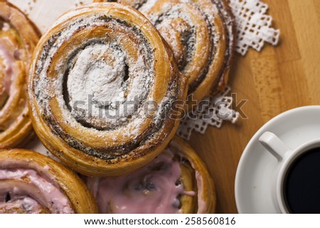 Homemade pastries with poppy seeds, sugar, icing and coffee.