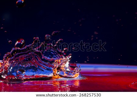 Flying, falling drops, sprays, splashes of water on a background in tones of acid hipster.