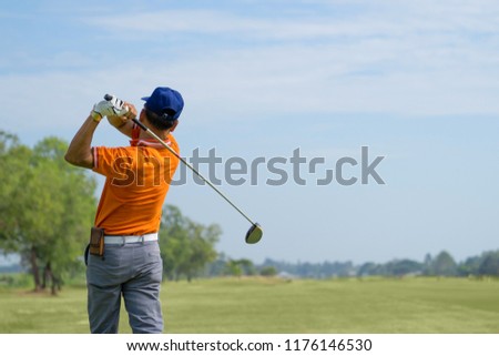 Golfer hitting golf shot with club on course vintage color tone, Man playing golf on a golf course in the sun, Golfers hit sweeping golf course in the summer
