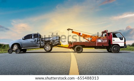 Tow truck delivers the damaged vehicle, Sun light flare, Selective focus