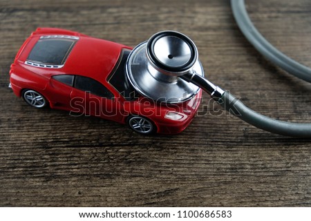 Stethoscope and car on the wooden background, Concept of car check-up, repair and maintenance.