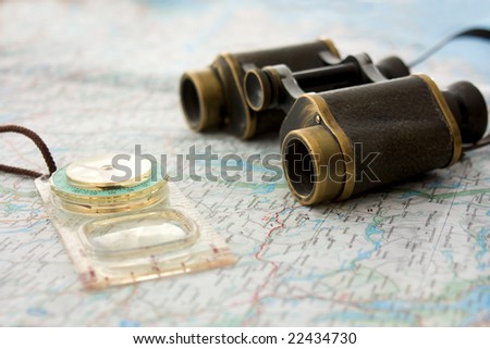 binocular and compass on the map