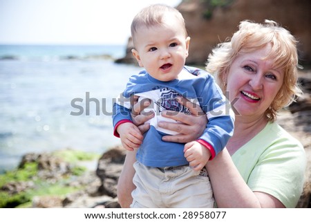 outdoor portrait of beautiful granny and her grandson