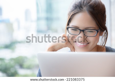 happy communication-Asian woman is smiling at her laptop