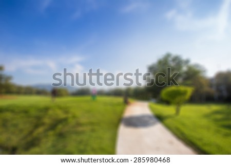 green field and blue sky at golf club blurred background