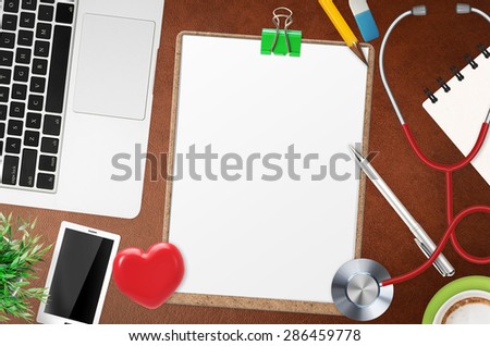doctor office desk with blank clipboard