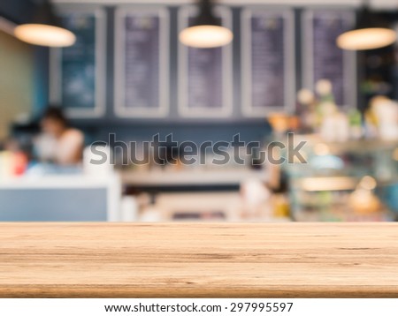 wooden counter top with bakery shop blurred background
