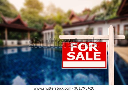 for sale sign at luxury house with pool background