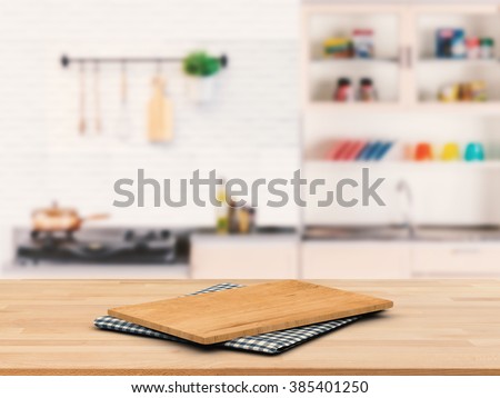 chopping board on wooden counter top with kitchen cabinet background