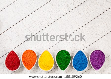 A rainbow border of colorful baking sprinkles used for decorating cookies and cakes