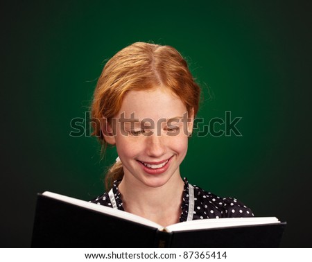 Portrait of a smart young girl enjoying a good book.
