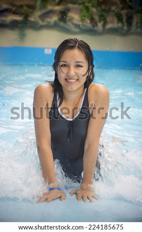 Asian woman in pool in aqua park
