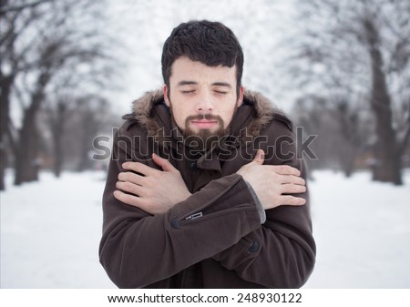 haired bearded man in cold winter snow park