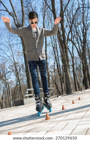 The guy on roller skates. Man riding between cones on roller skates