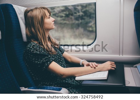 woman is reading the book on fast train