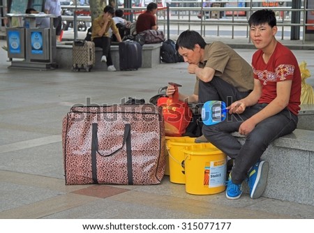 SHANGHAI, CHINA - JULY 2, 2015: people are waiting in train station of Shanghai