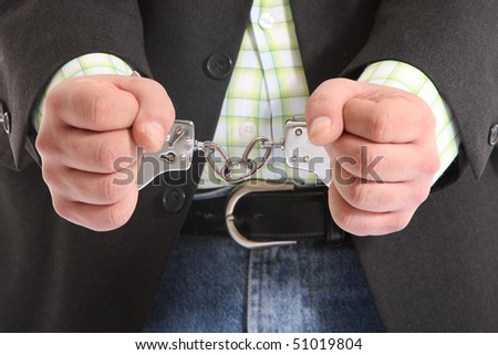 suited guy in handcuffs