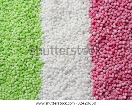 Dried white, green and pink colored sago pearls arranged to resemble the italian flag
