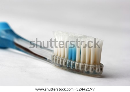Worn out toothbrush with wear indicator faded halfway