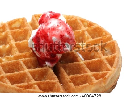 Close up of a waffle pancake with strawberry ice cream