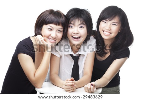 A group of three asian Chinese teenagers friends in college sharing a laughing, happy moment