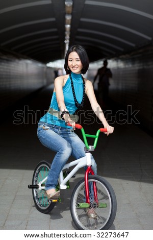 Quirky photo of well dressed woman on street bike