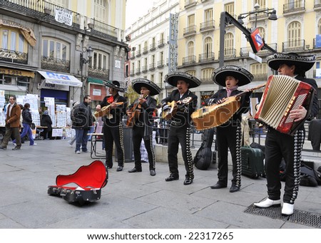 stock-photo-madrid-spain-nov-street-musicians-in-traditional-dress-playing-in-the-plaza-de-la-puerta-del-22317265.jpg