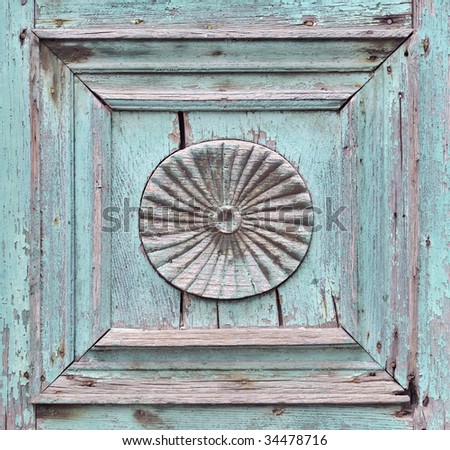 Closeup of panel detail on old green wooden door