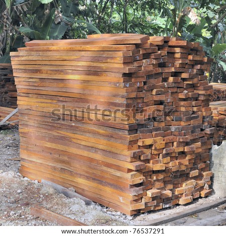 Asian tropical hardwood timber stacked outside lumber yard
