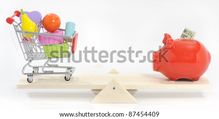 Saving and balanced spending concept savings pig and shopping cart on seesaw