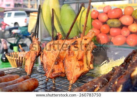 grilled chicken thai style on display street food shop in thailand