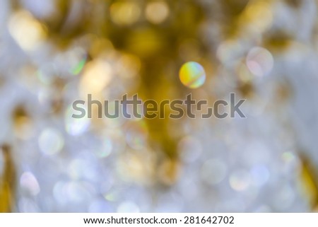 blurred of white and gold bokeh background from chandelier