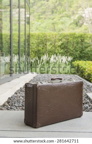 vintage leather luggage in front of resort, thailand