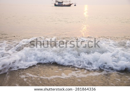 moving of wave to sand beach , sunset